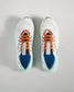 Top view of a modern white athletic shoe with orange and blue accents showcasing breathable mesh and a lightweight design