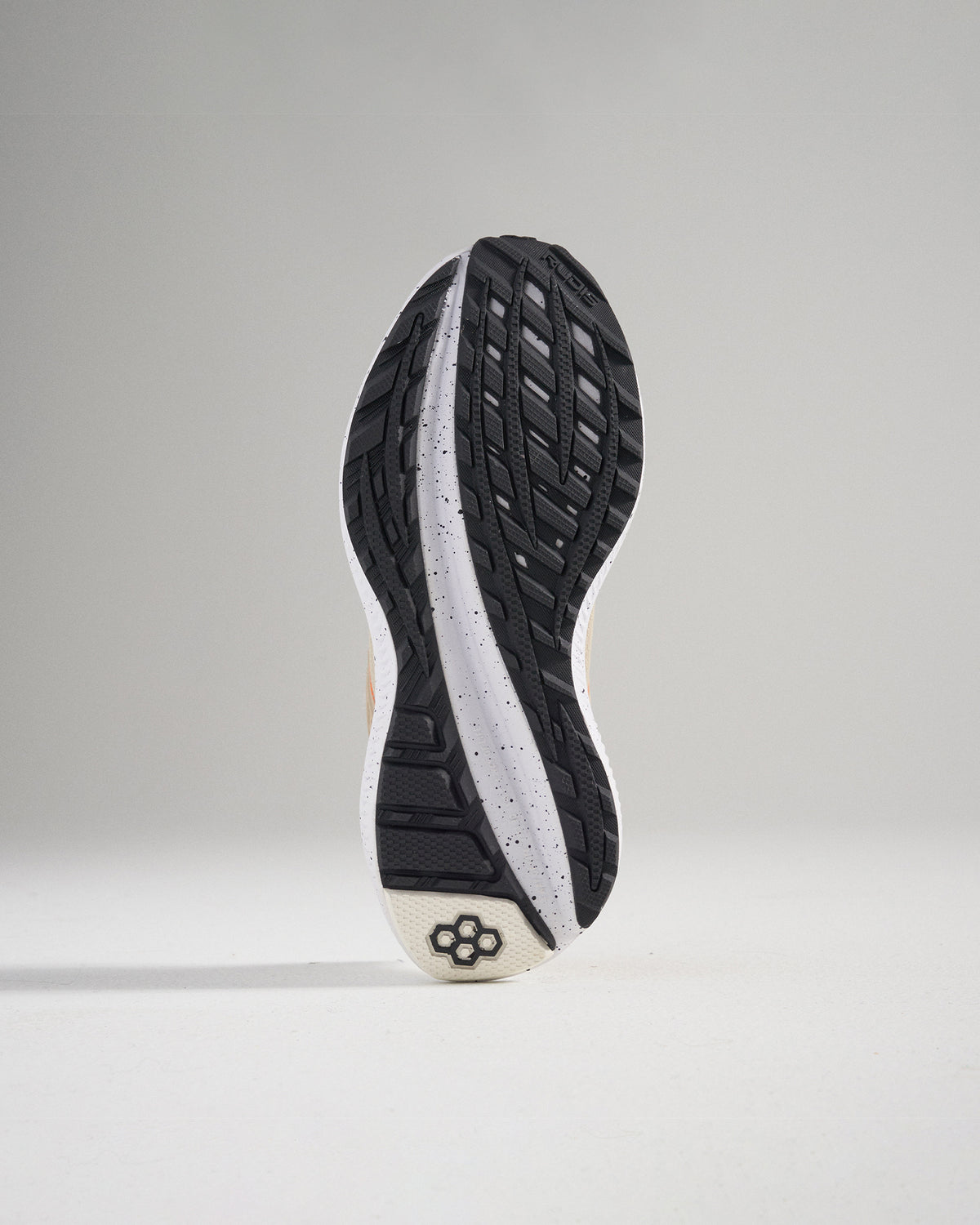A close-up view of the sole of a running shoe highlighting its intricate tread design and cushioning technology
