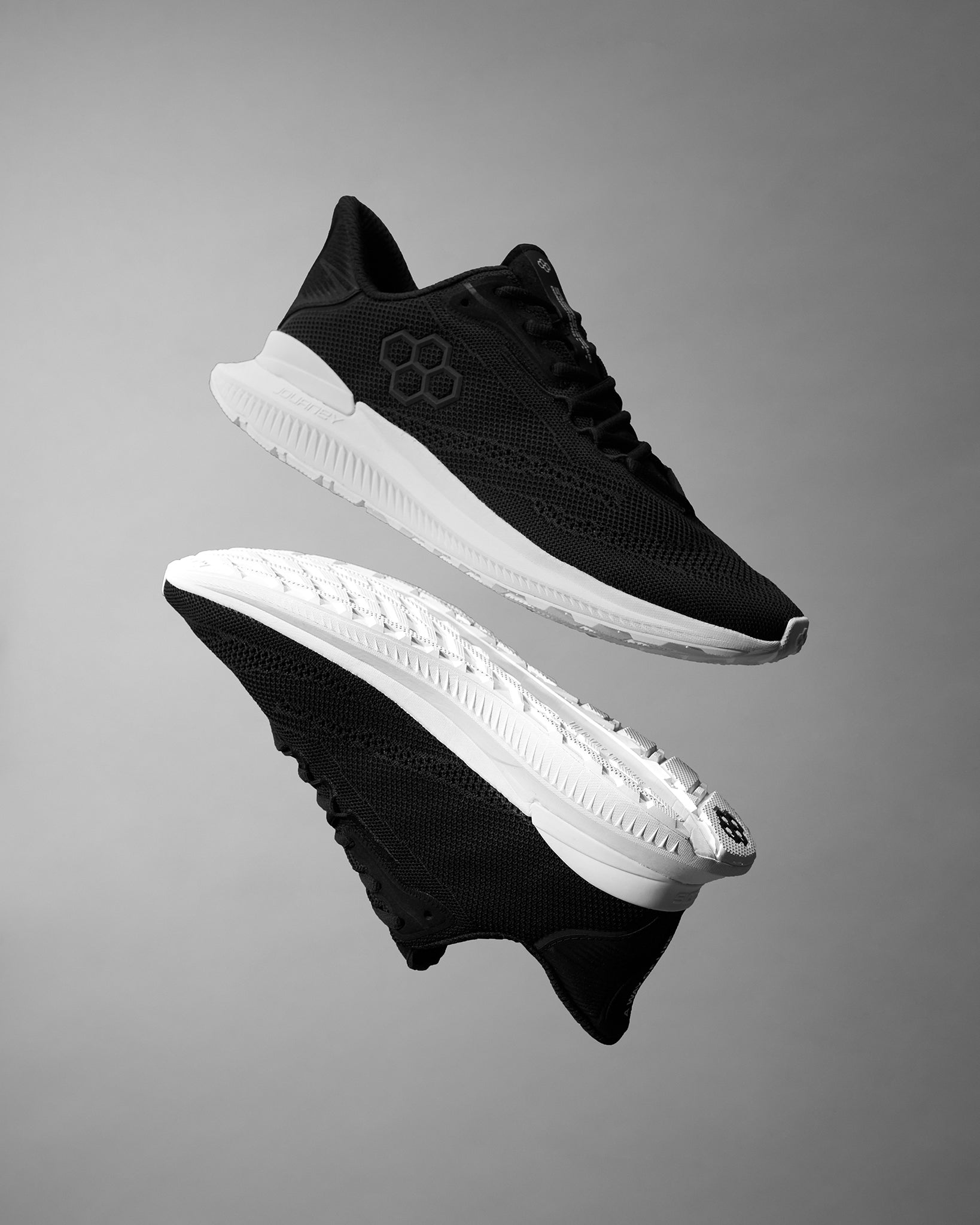 Black and white athletic shoes on a gray background