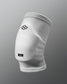 A white knee sleeve designed for sports protection featuring a hexagonal logo and a branded label at the bottom