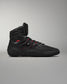 High-top athletic shoe in black with red accents, featuring a textured surface for grip, padded collar for comfort, and a durable design suited for athletic activities.