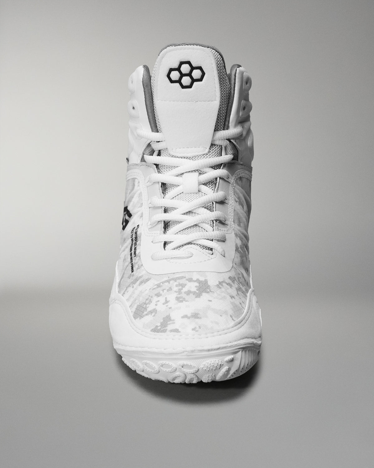 High-top wrestling shoe showcases a white camo design and textured sole, featuring a padded collar and reinforced toe for sports performance.