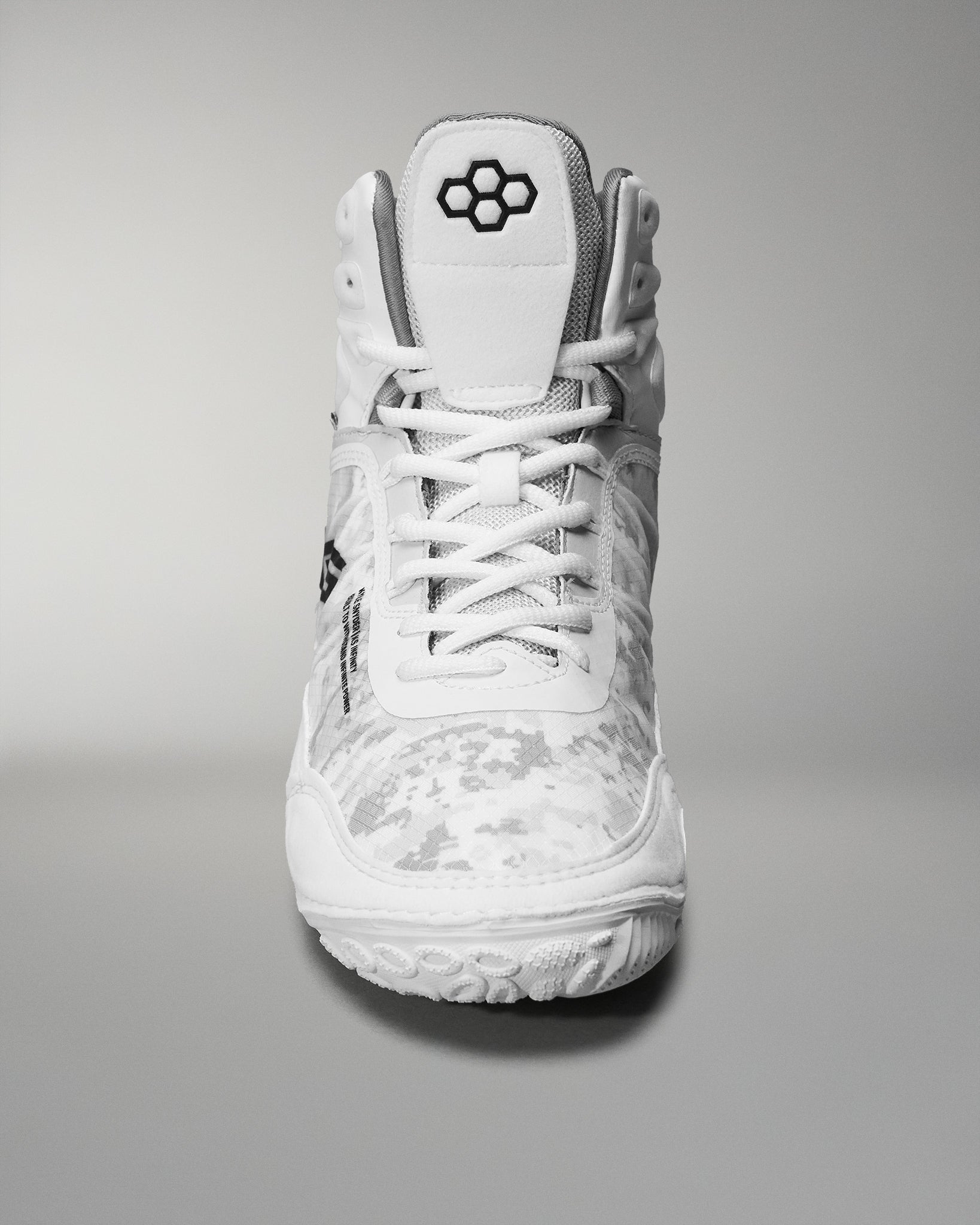 High-top wrestling shoe showcases a white camo design and textured sole, featuring a padded collar and reinforced toe for sports performance.