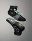 Black and gray wrestling shoes with green accents on a gray background