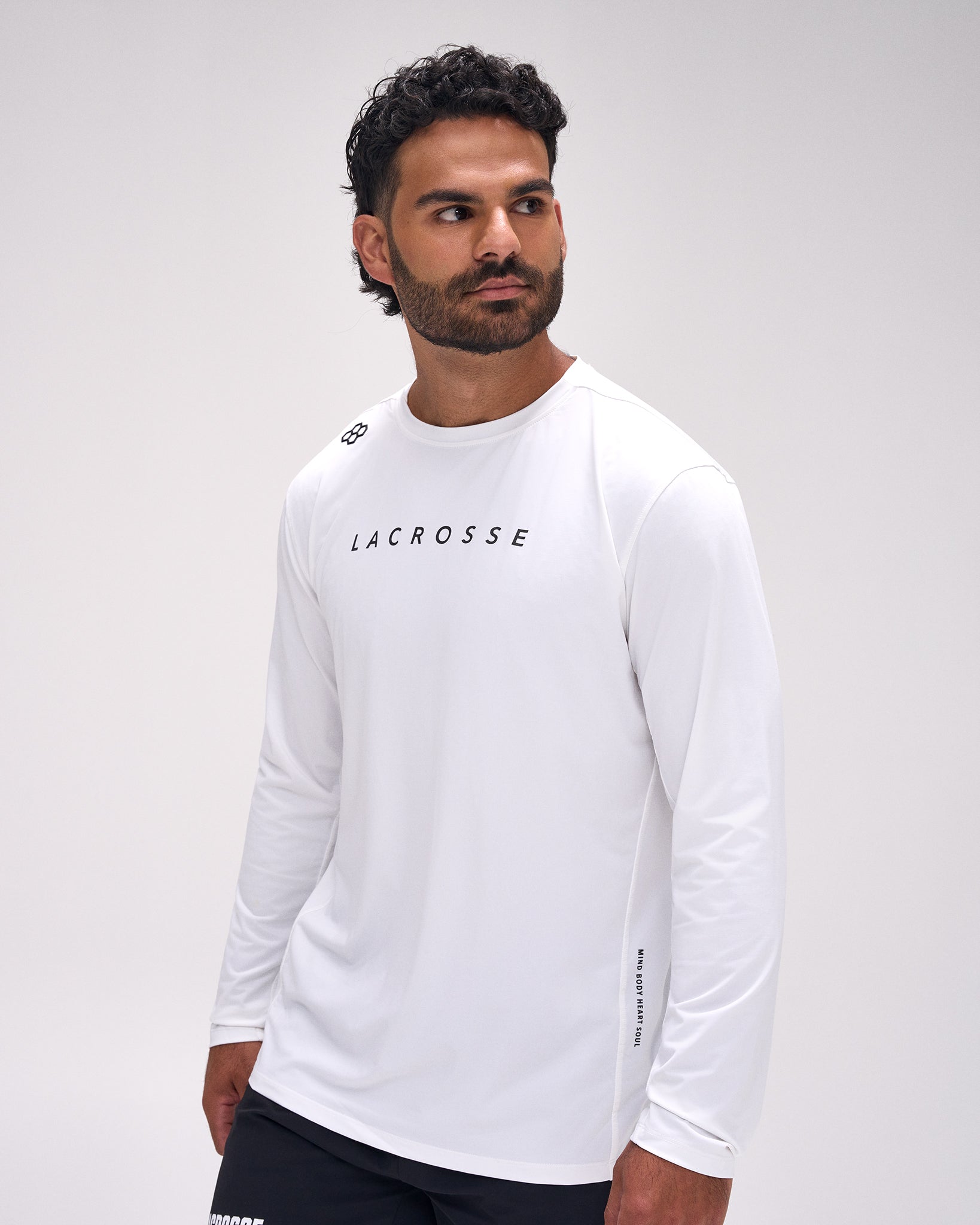 Male athlete wearing the RUDIS Lacrosse Performance Heather Long Sleeve in Heather White featuring lightweight moisture-wicking fabric, athletic fit, and minimalist Lacrosse graphic.