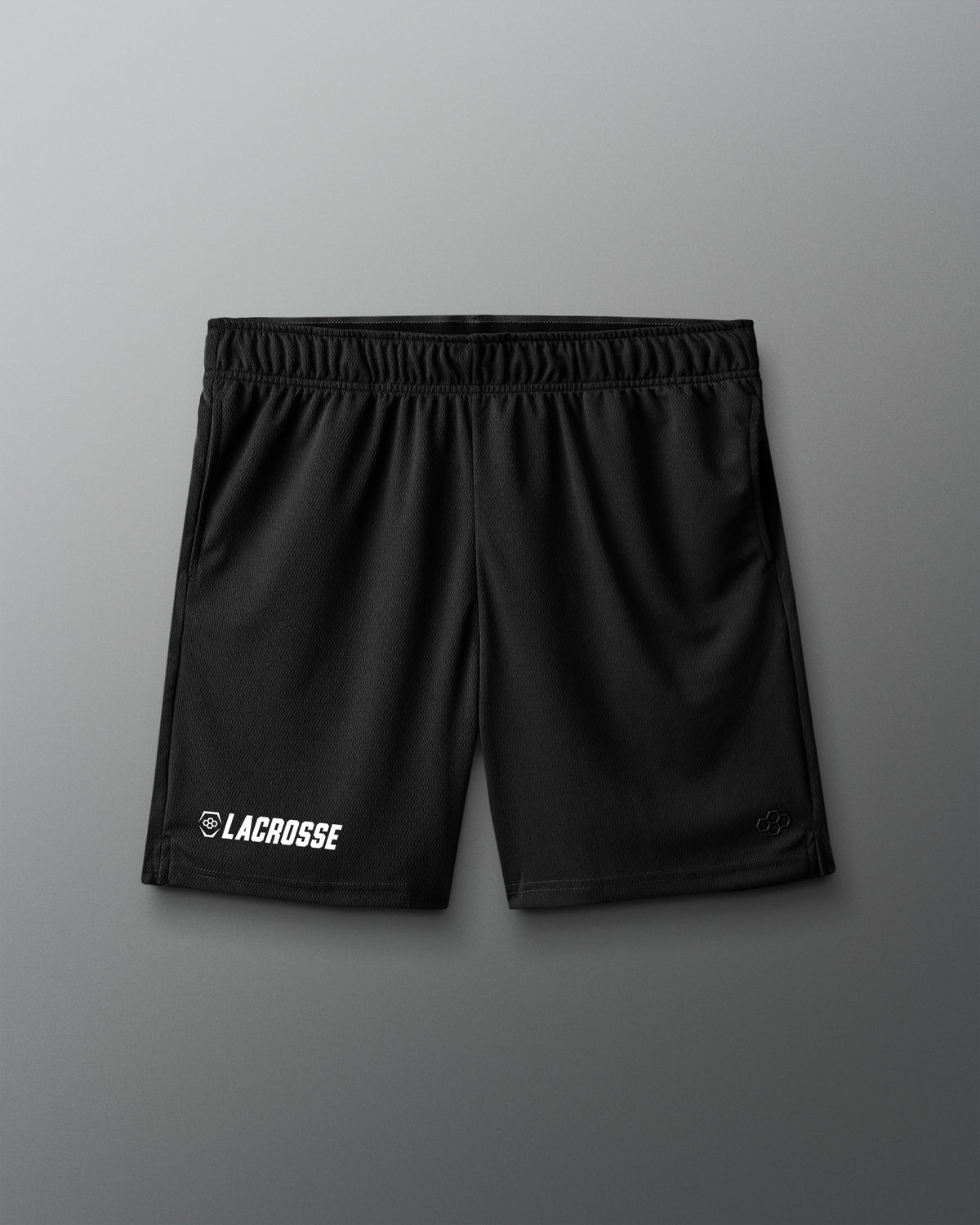 Black lacrosse shorts on a gray background