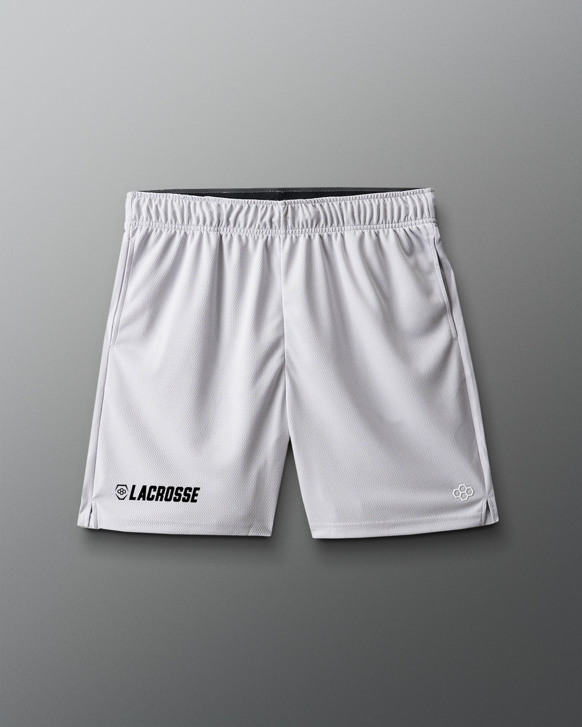 White lacrosse shorts on a gray background