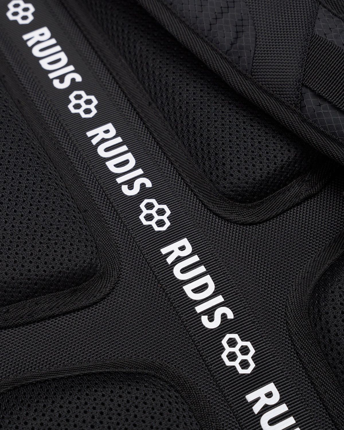 Black protective gear with 'RUDIS' branding on a black background