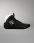 Black wrestling shoe with white accents on a gray background