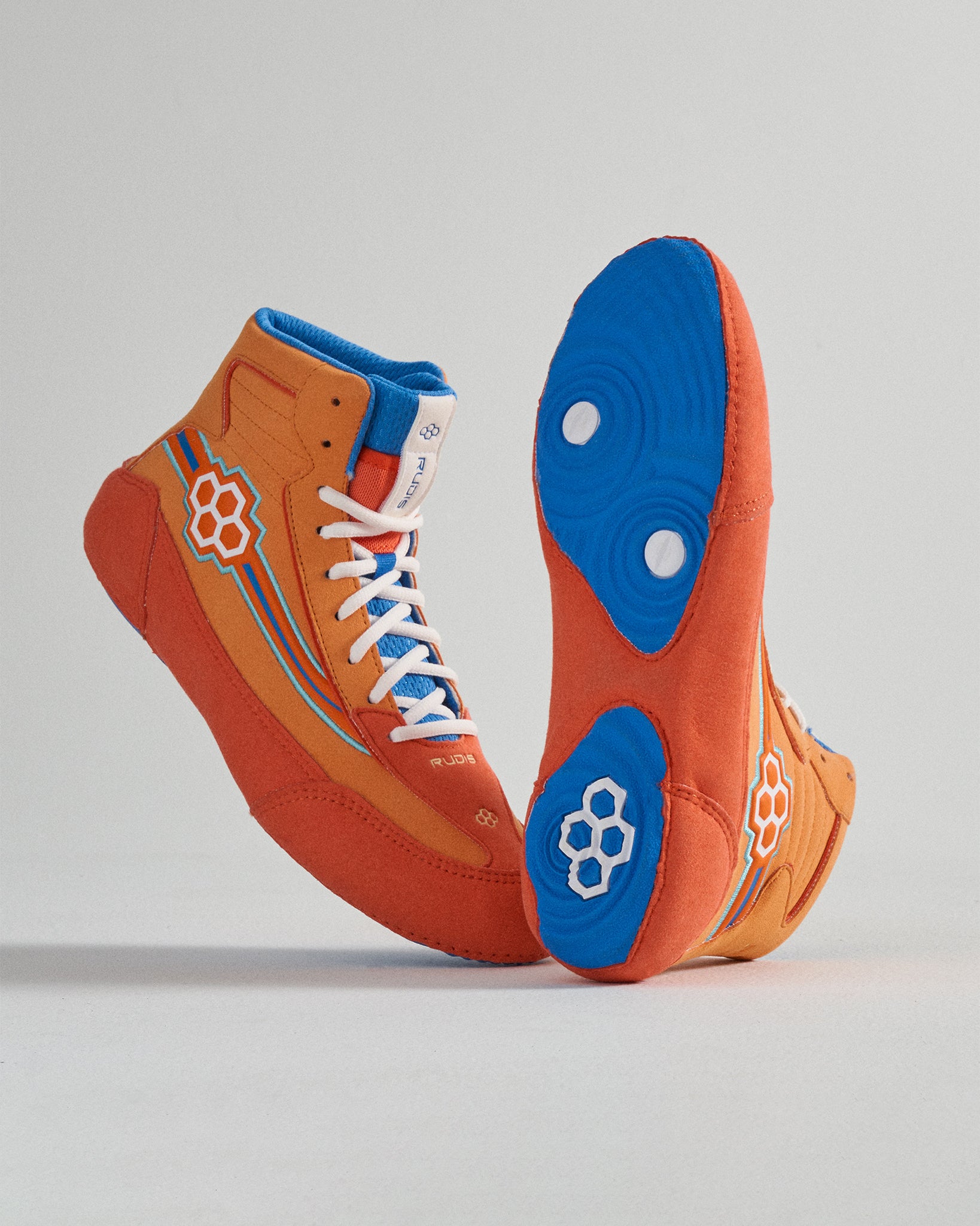 Vibrant orange high-top sneakers featuring blue accents and a stylish design ideal for athletic or casual wear