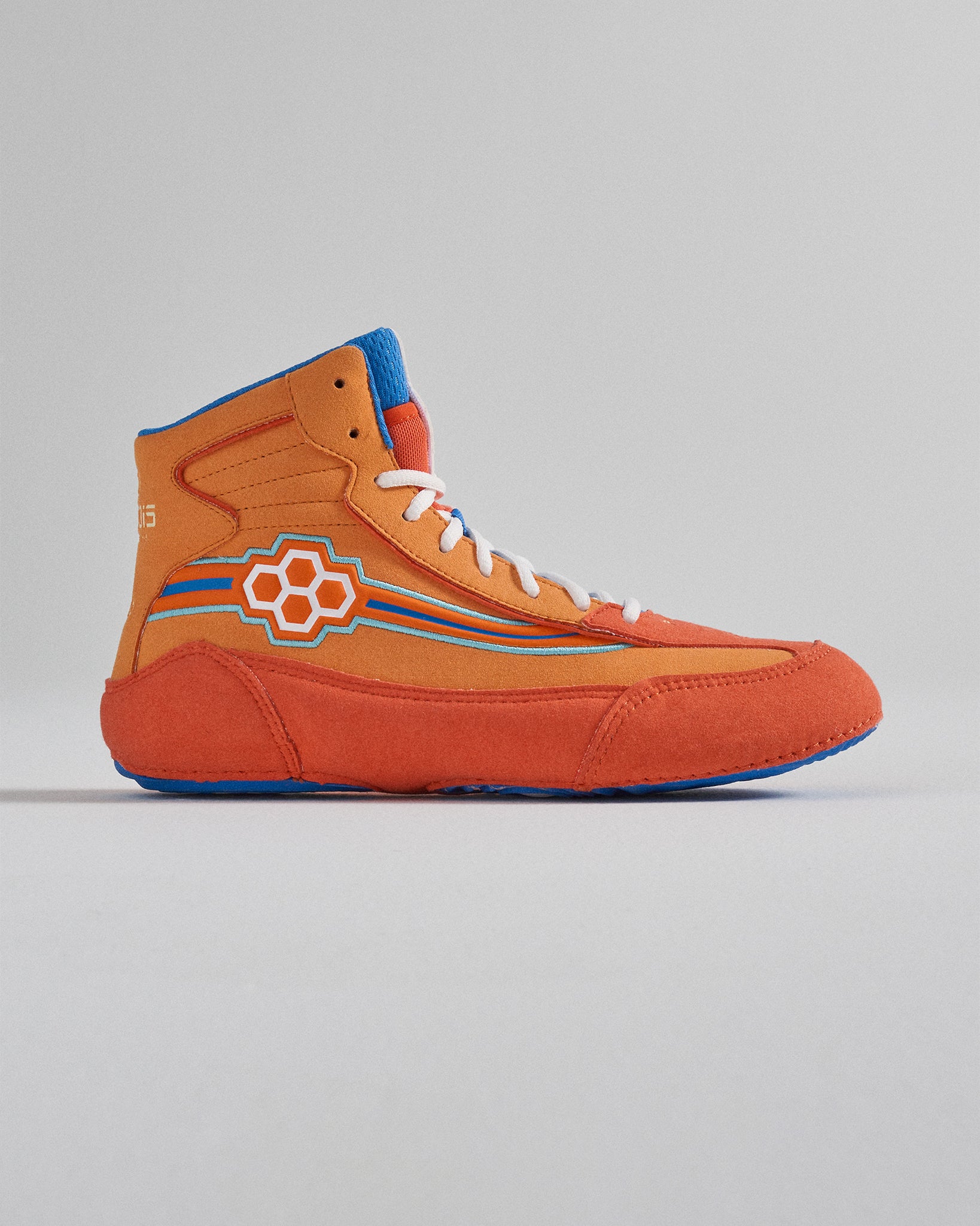 A vibrant orange high-top sneaker featuring blue accents and a hexagonal logo design