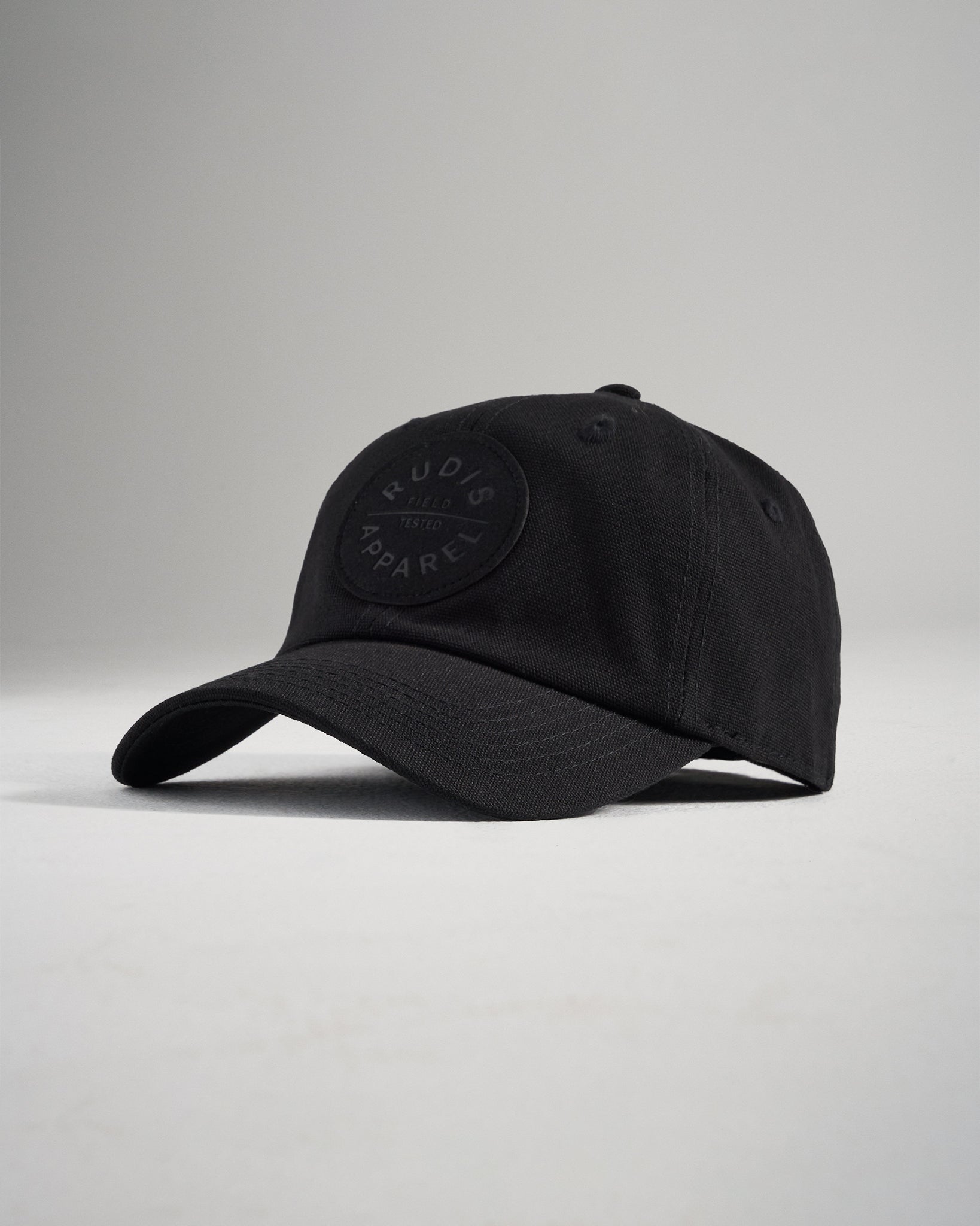 A sleek black cap featuring a circular logo on the front