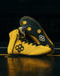 Yellow RUDIS Rocky International Wrestling Shoes staged together with one shoe displaying the black traction outsole. Italian stallion logo on the tongue