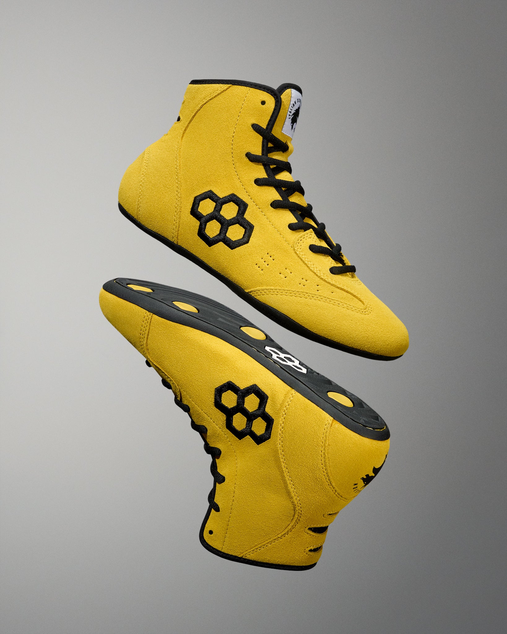 Pair of yellow RUDIS Rocky International Adult Wrestling Shoes arranged to showcase the upper and outsole designs.