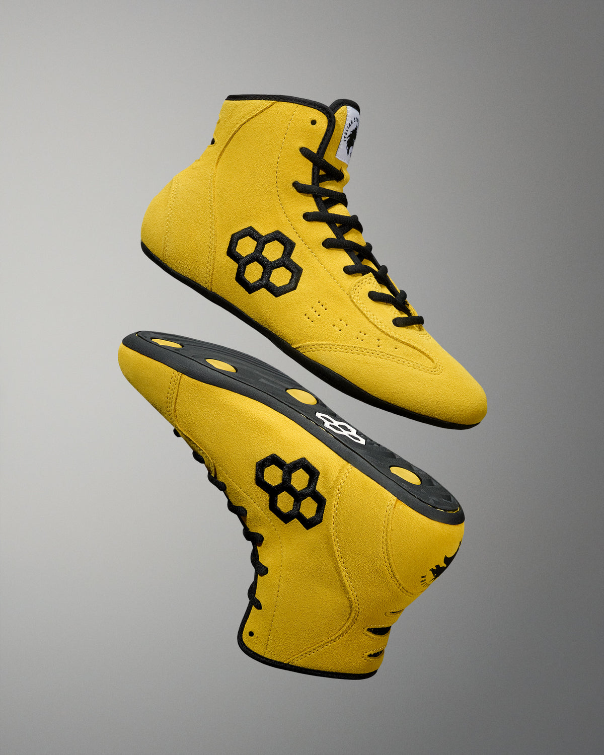Pair of yellow RUDIS Rocky International Adult Wrestling Shoes arranged to showcase the upper and outsole designs.