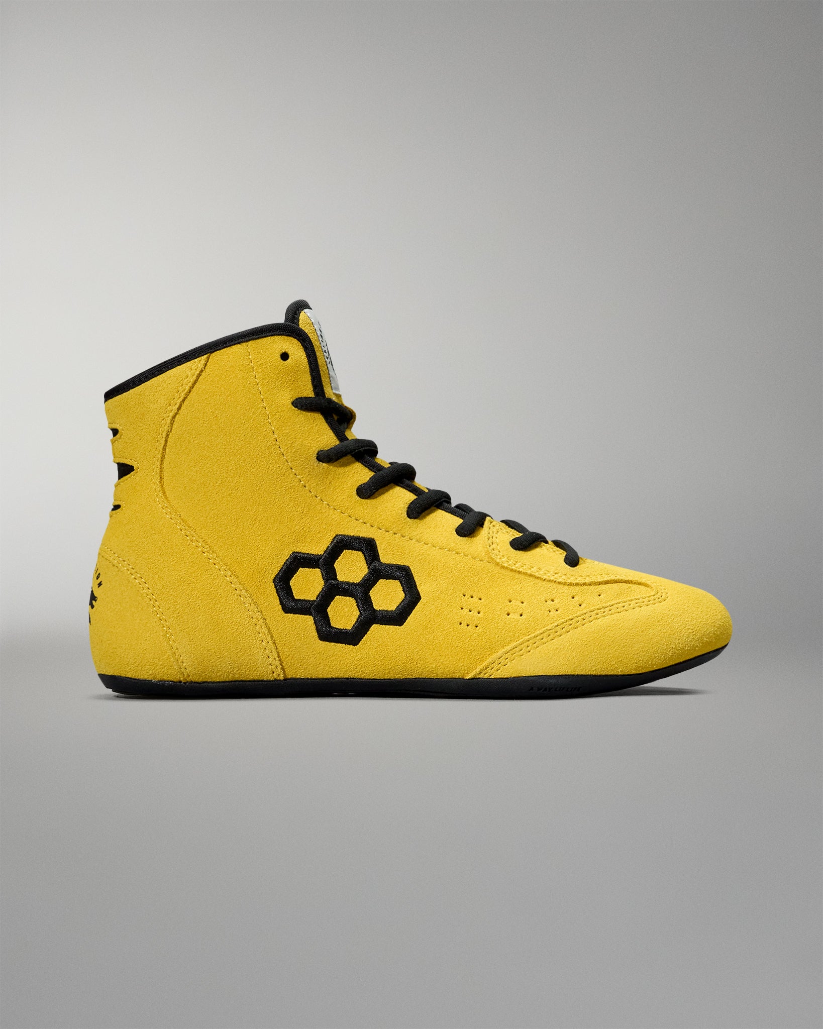 Opposite side profile of the yellow RUDIS Rocky International Wrestling Shoe featuring black logo embroidery and perforated details.