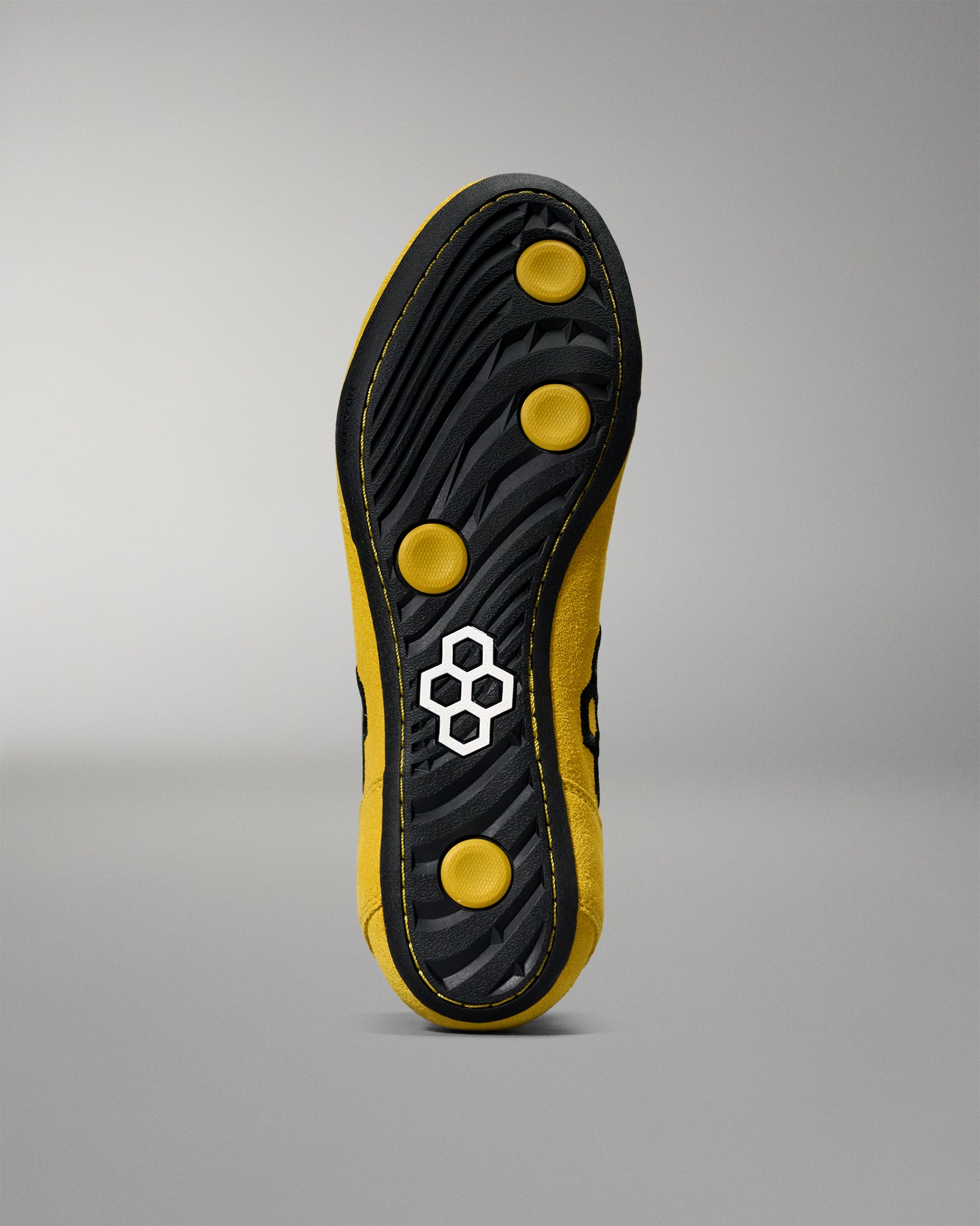 Bottom view of the RUDIS Rocky International Wrestling Shoe showing the black outsole, traction pattern, and yellow grip pods.