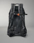 Black backpack with orange accents on a gray background