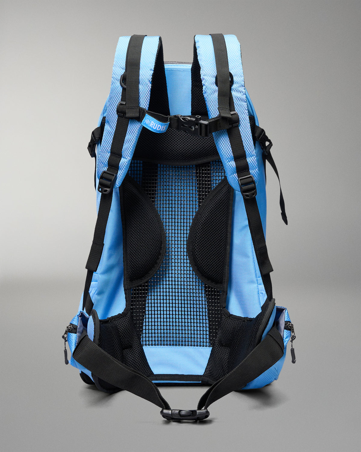 The back view of a light blue and black hiking backpack, showing the padded mesh backrest, shoulder straps, and compression buckles against a neutral gray background.