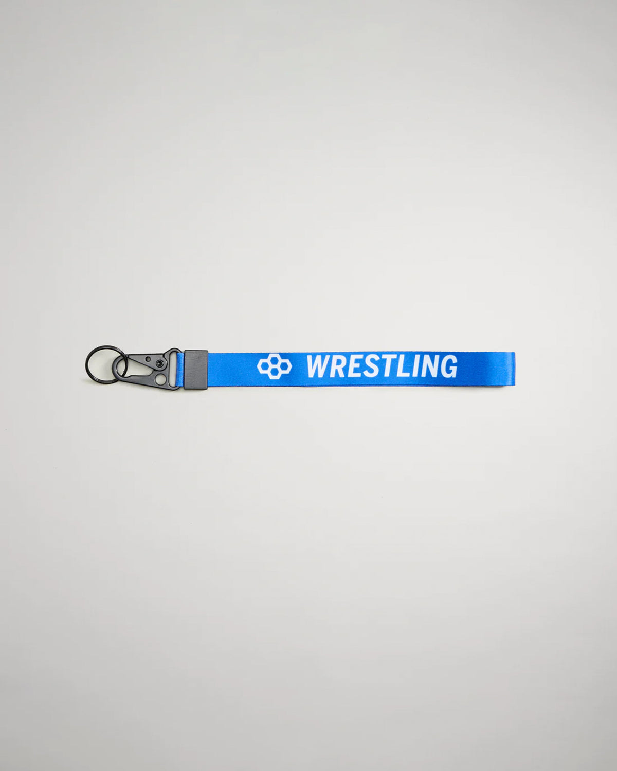 A vibrant blue wrestling keychain featuring the word WRESTLING in bold white letters and a black clip for attachment