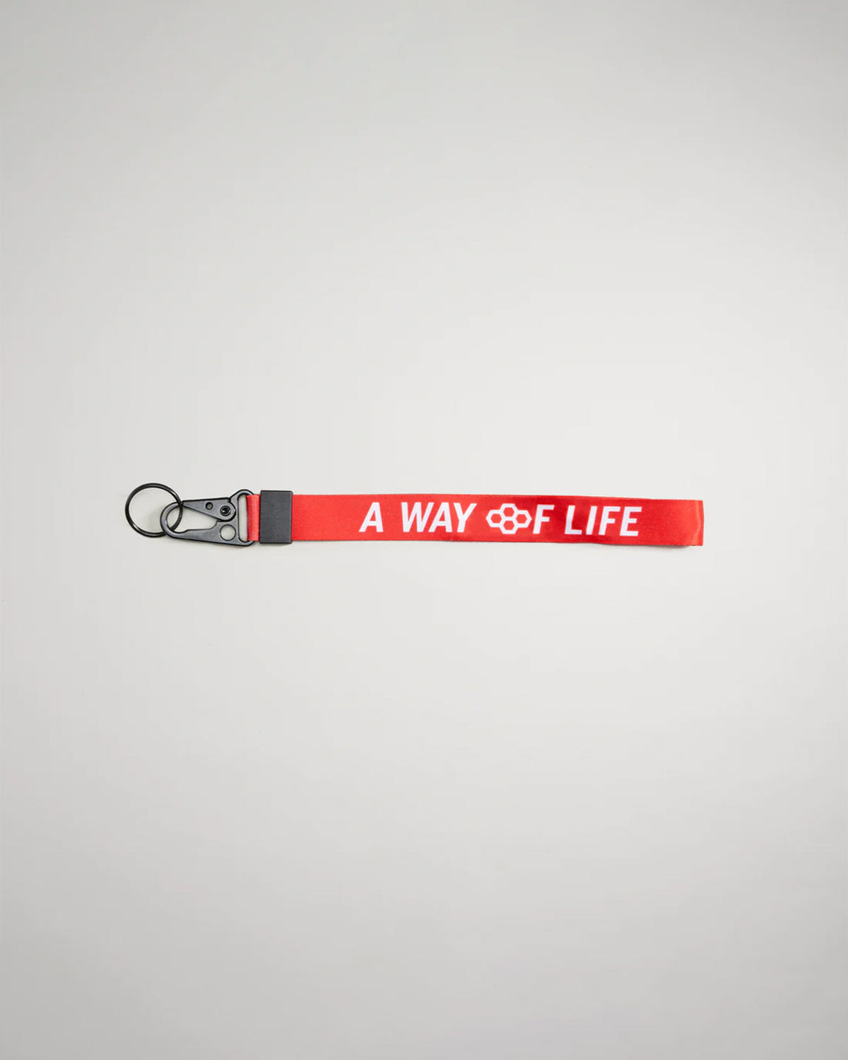 A vibrant red keychain strap featuring the phrase A WAY OF LIFE in bold white lettering designed for functional and stylish use