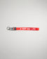 A vibrant red keychain strap featuring the phrase A WAY OF LIFE in bold white lettering designed for functional and stylish use
