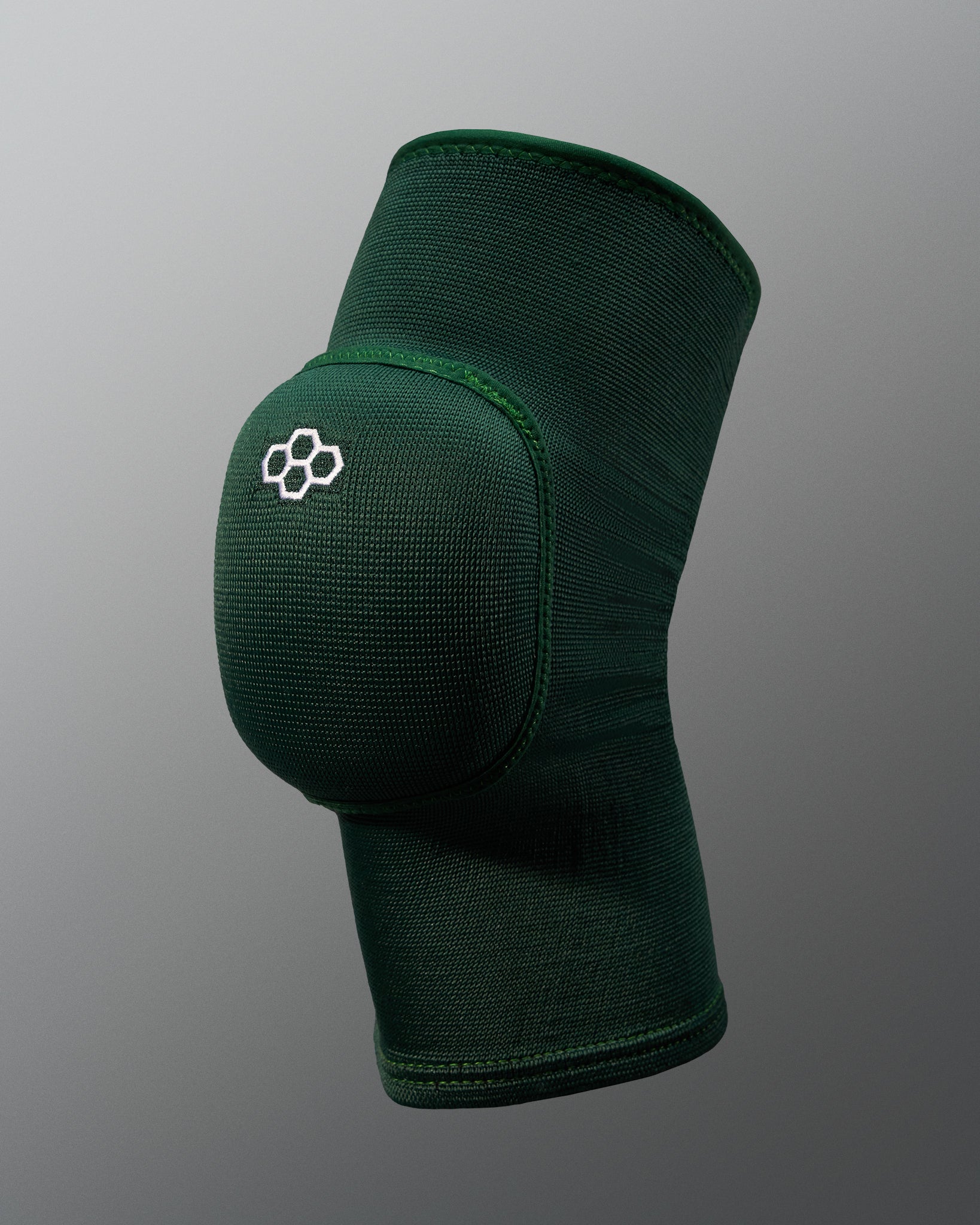 Green knee pad with a logo on a gray background