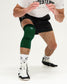 Person wearing a green knee pad on a white background