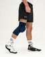 Person wearing navy knee sleeves on a white background