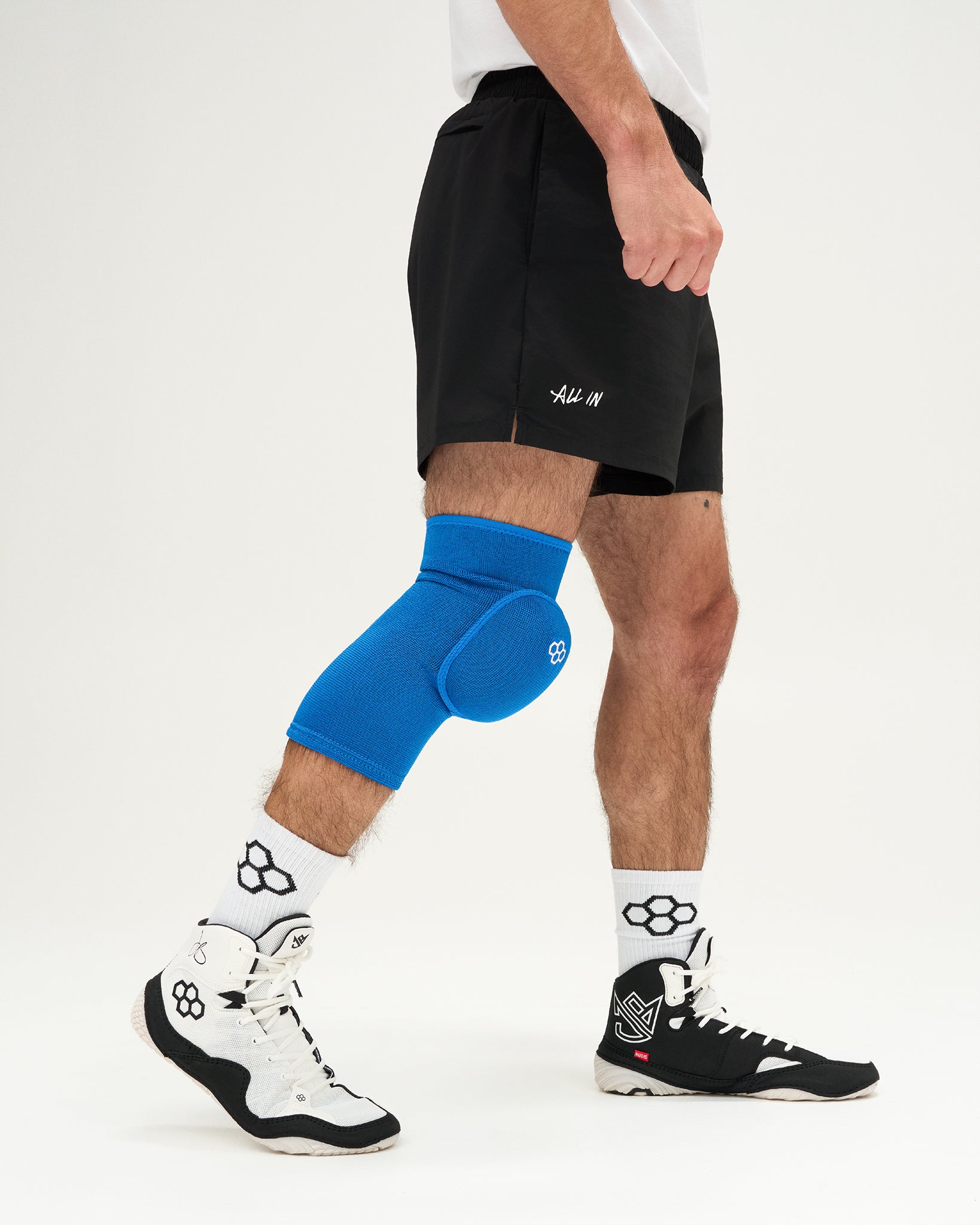 Person wearing blue knee pads on a white background