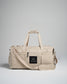This image features a stylish beige duffel bag designed for versatility showcasing its sleek exterior and brand logo for practical use in various settings