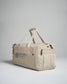A modern beige utility duffel bag featuring multiple compartments sturdy handles and a mesh pocket ideal for travel or gym use