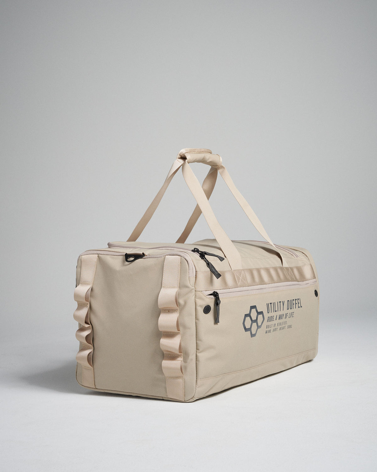 A stylish beige utility duffel bag featuring multiple zip pockets sturdy handles and a modern design
