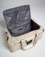 A light beige utility duffel bag with an open top showcasing ample storage space and a fine mesh pocket inside the lid