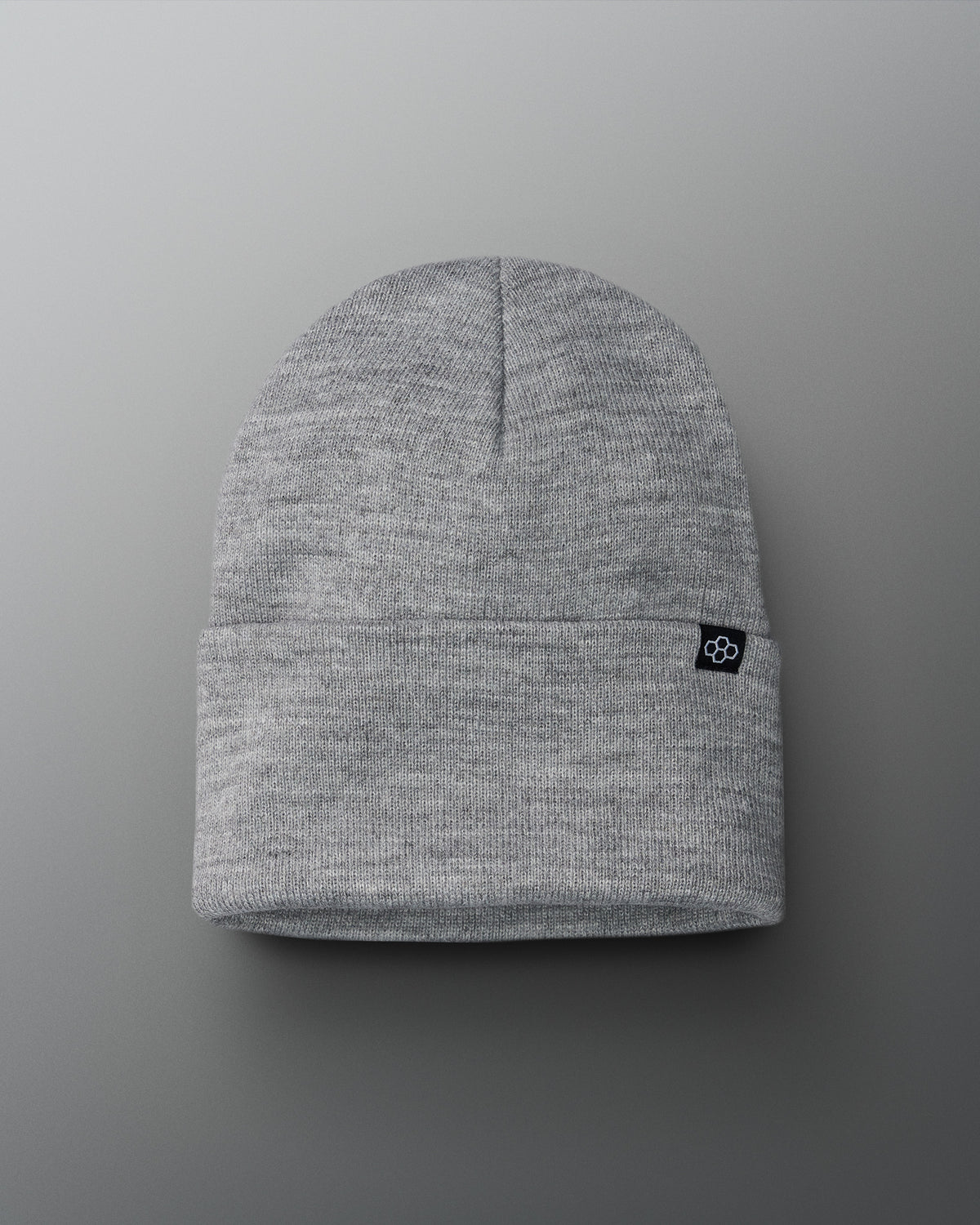 Gray beanie with a small logo on a gray background