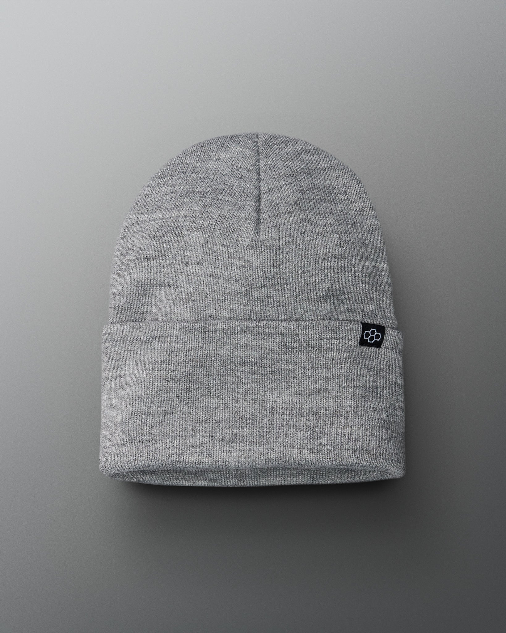 Gray beanie with a small logo on a gray background