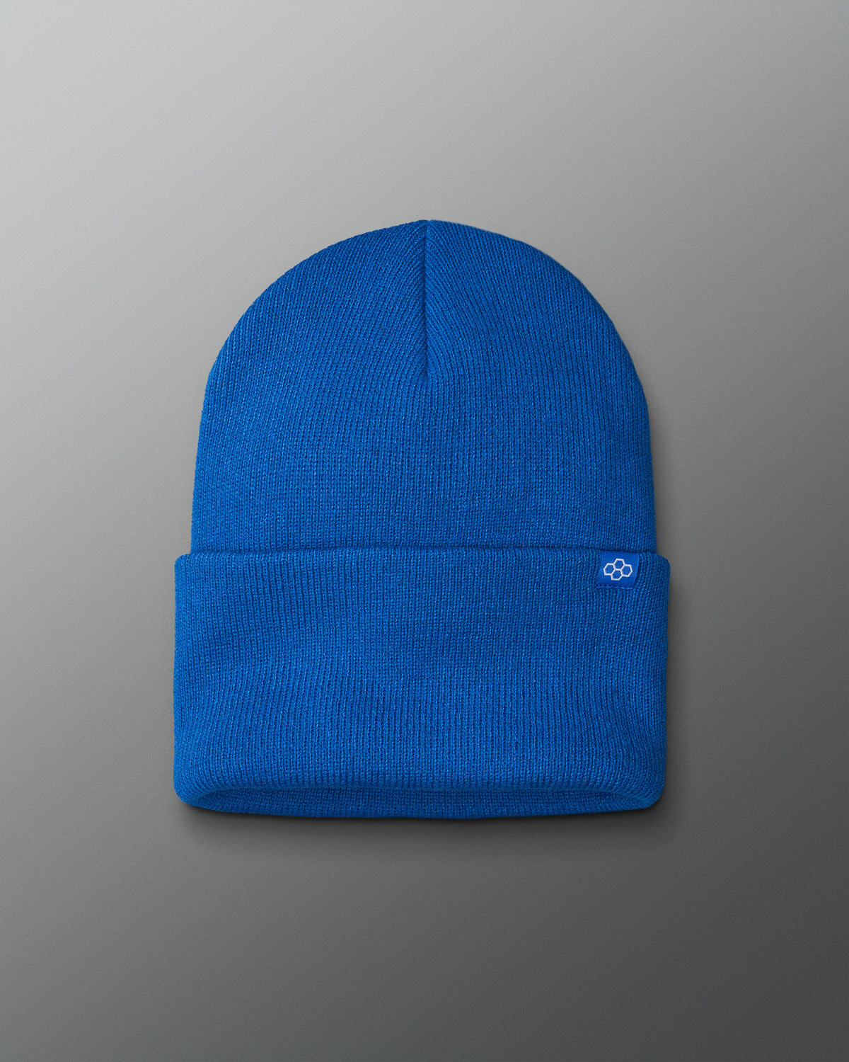 Blue beanie with a logo on a gray background