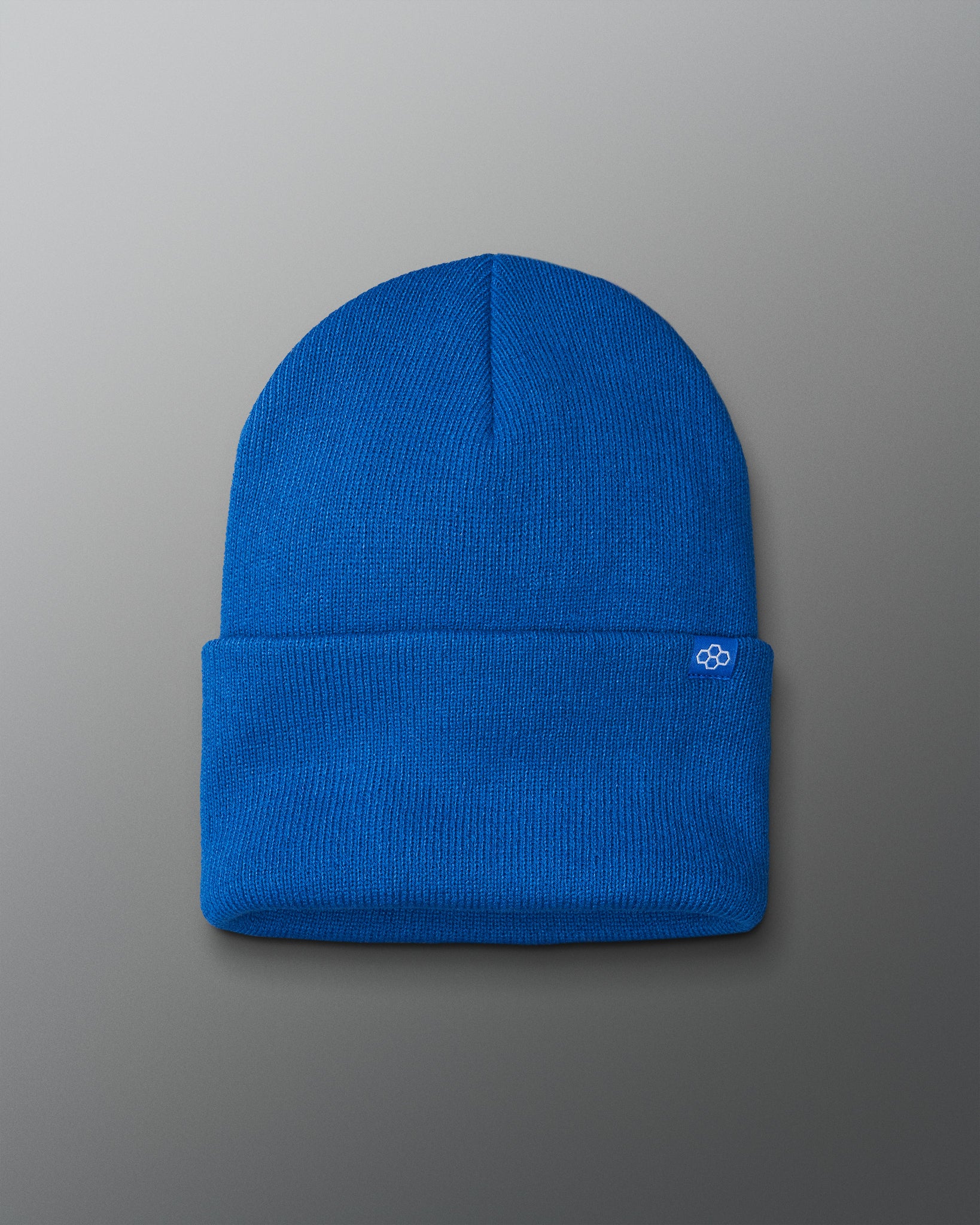Blue beanie with a logo on a gray background