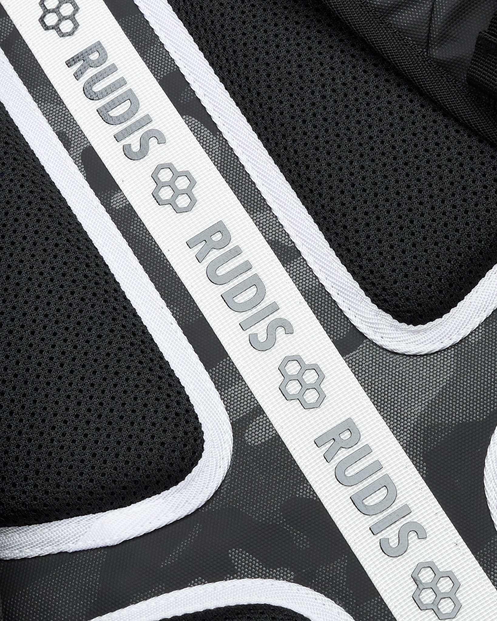 Close-up of a black and gray product with 'RUDIS' branding.