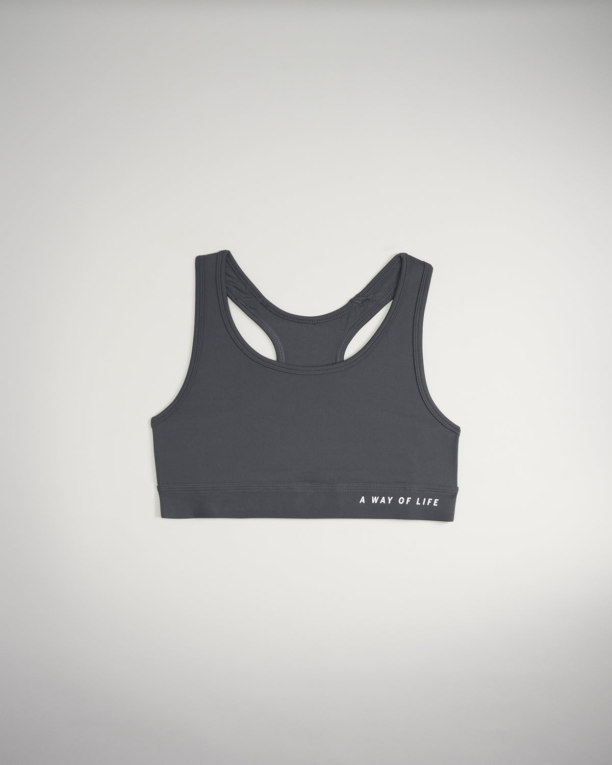A sleek gray sports bra featuring a racerback design and the phrase A WAY OF LIFE printed in white
