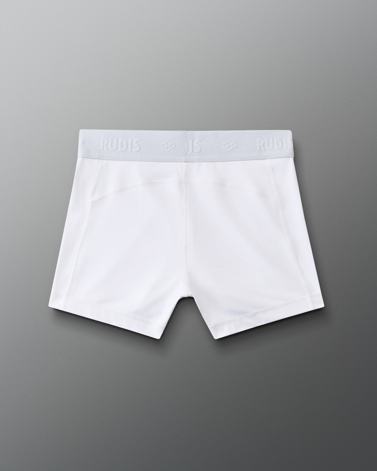 Back view of the RUDIS Women's Compression Shorts in White, showcasing the RUDIS-branded elastic waistband, contoured seam construction and fitted athletic design.