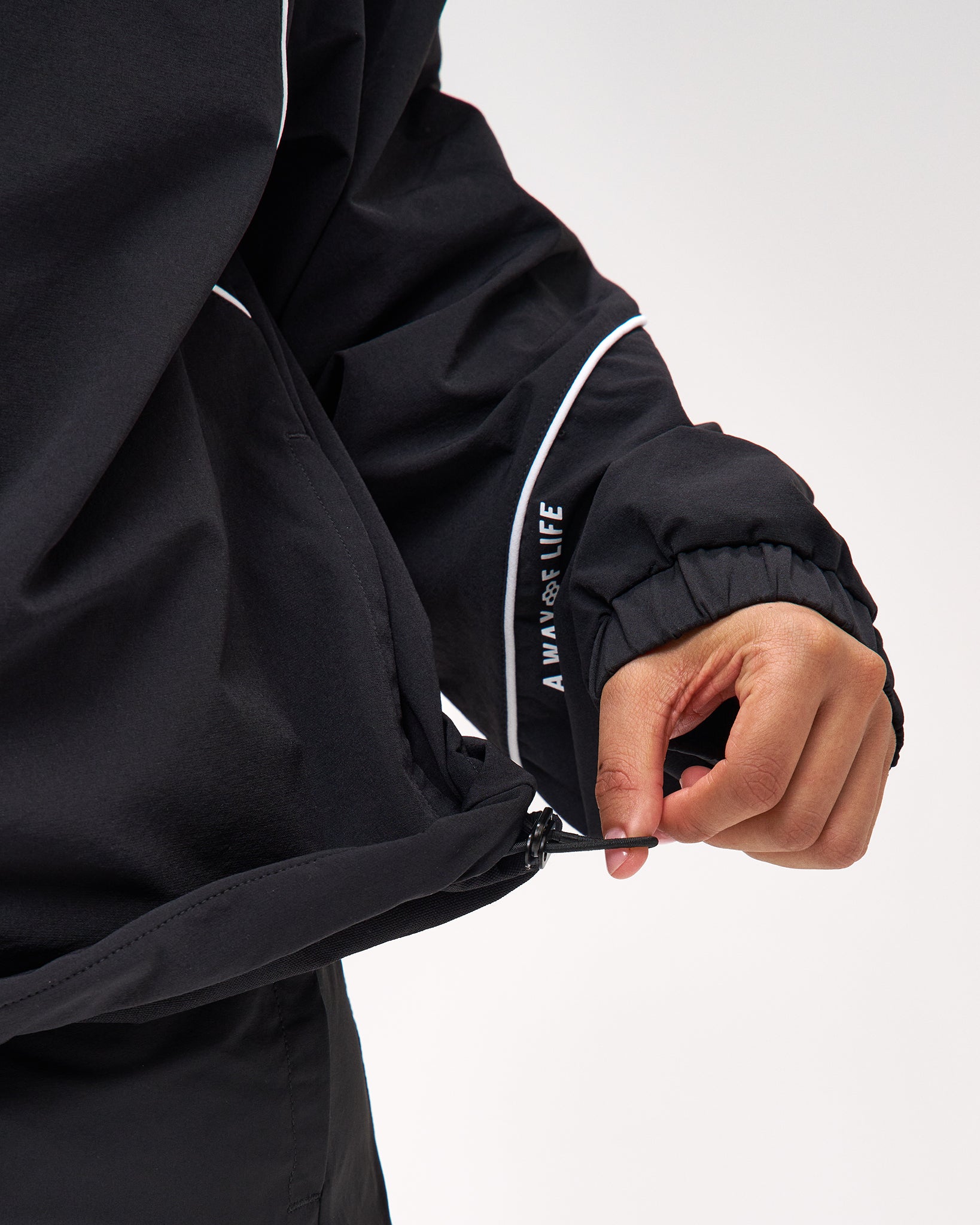 Black jacket with white piping and 'AWAYLIFE' branding on a light gray background