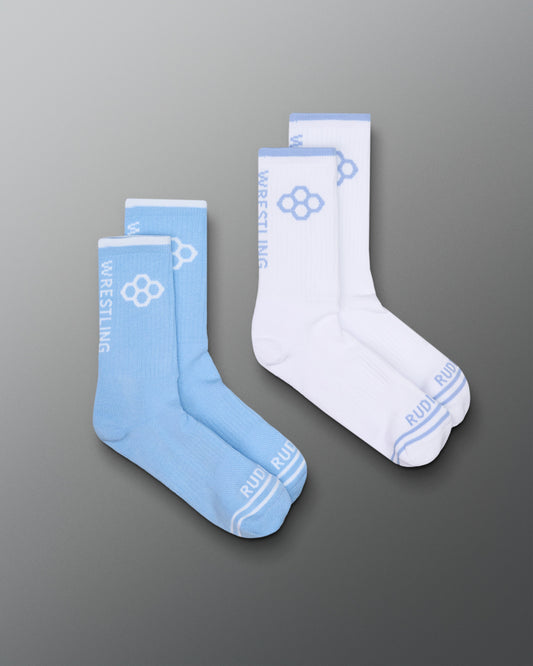 Two pairs of socks, one blue and one white, on a gray background.
