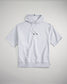A light gray short-sleeved hoodie featuring a drawstring hood and a relaxed fit ideal for casual wear or layering
