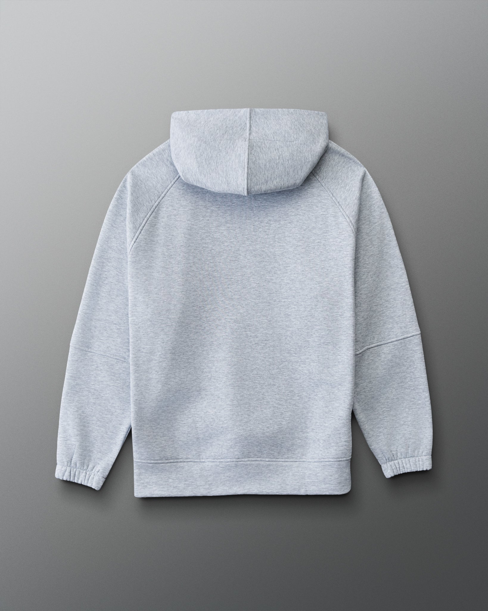 A light gray heather pullover hoodie shown from the back, laid flat against a dark gray gradient background.