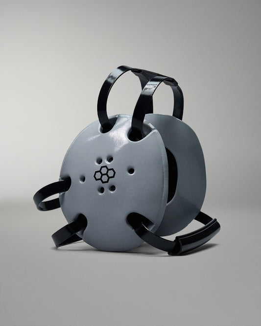 Grey wrestling headgear with black RUDIS logo. Black straps.