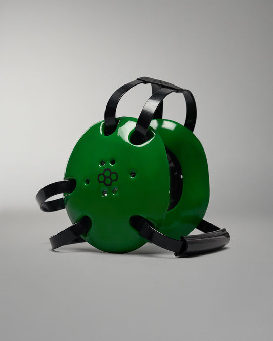Green reel with black straps on a gray background