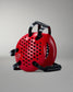 Red wrestling headgear with black handle and straps on a gray background