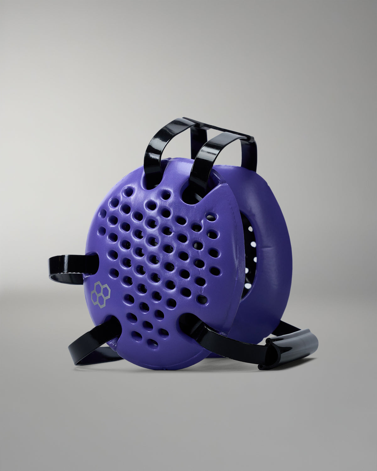 Purple wrestling headgear with black straps on a gray background