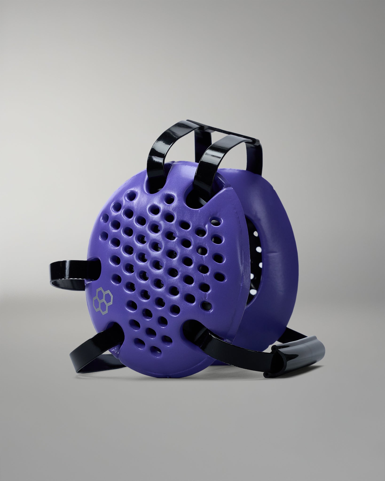 Purple wrestling headgear with black straps on a gray background